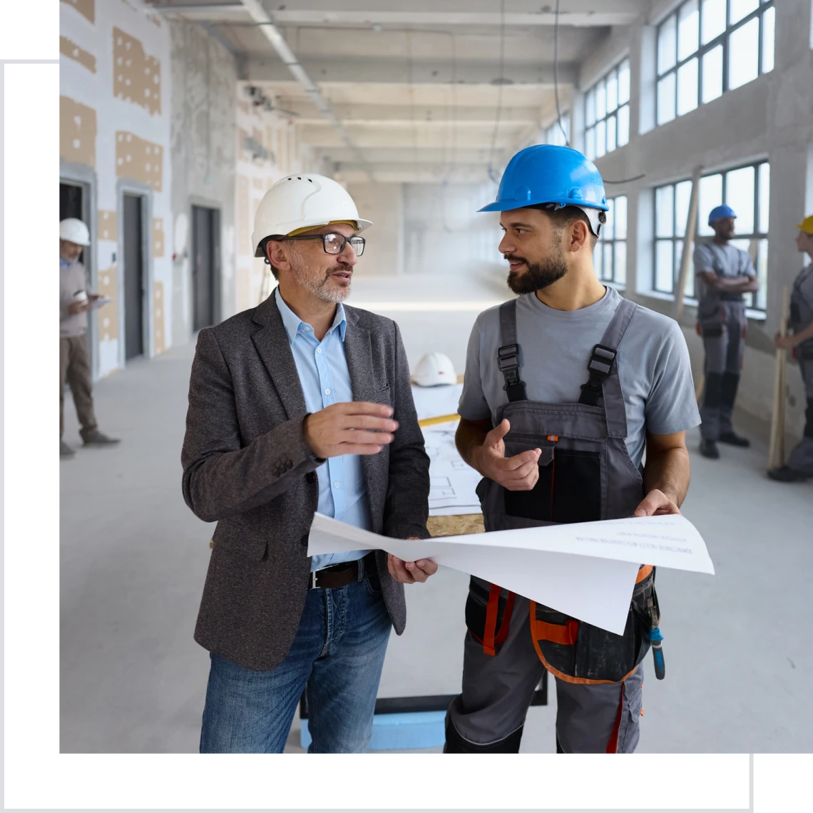 Construction workers reviewing building plans